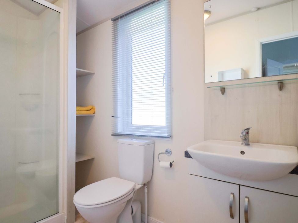 A bathroom with shower, toilet, and sink at 91 Swanage Coastal Park in Swanage
