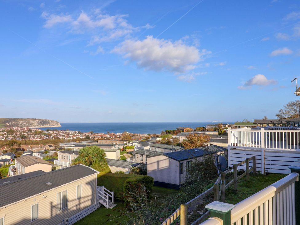A view of the sea and houses at 91 Swanage Coastal Park in Swanage