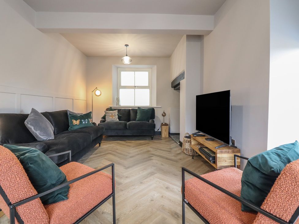 A living room with a sofa and armchairs at Green Bank in Betws-Y-Coed
