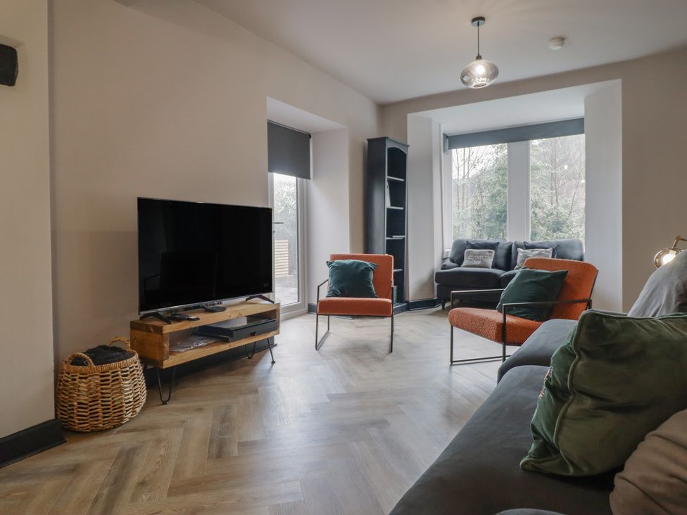 A living room with a television and seating area at Green Bank in Betws-Y-Coed