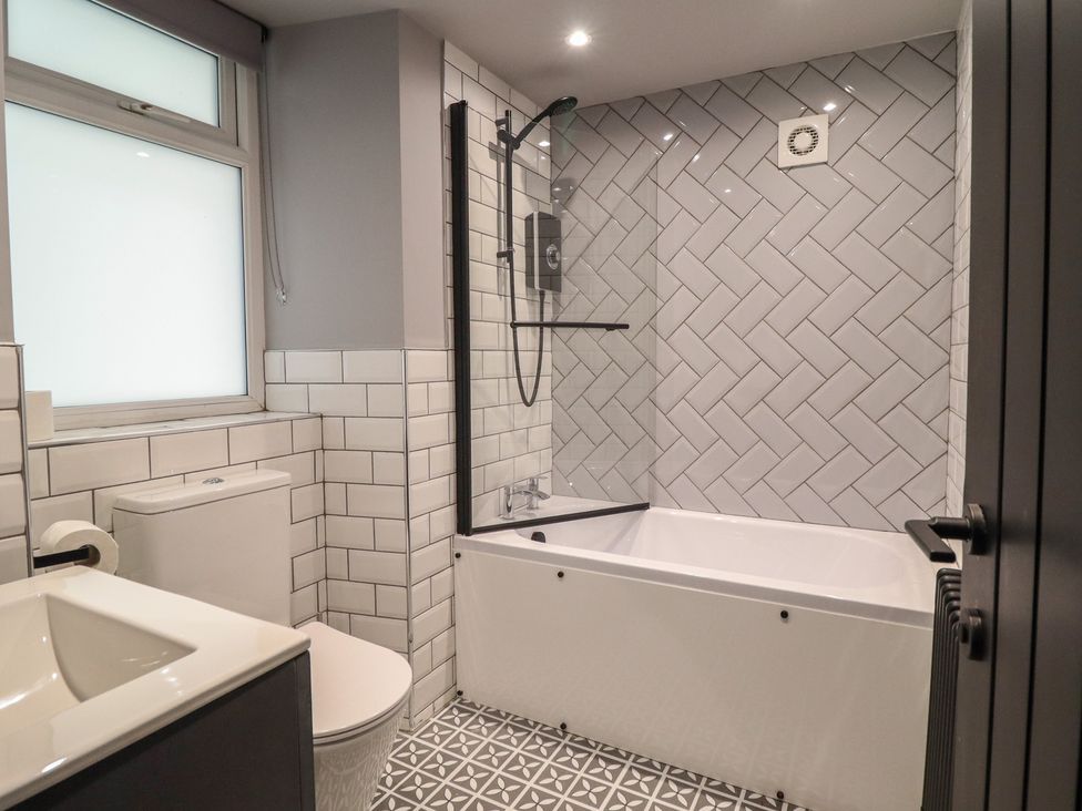 A bathroom featuring a bathtub, sink, toilet, and shower at Green Bank in Betws-Y-Coed