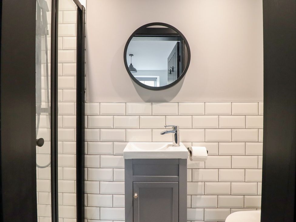 A bathroom with a sink and mirror at Green Bank in Betws-Y-Coed