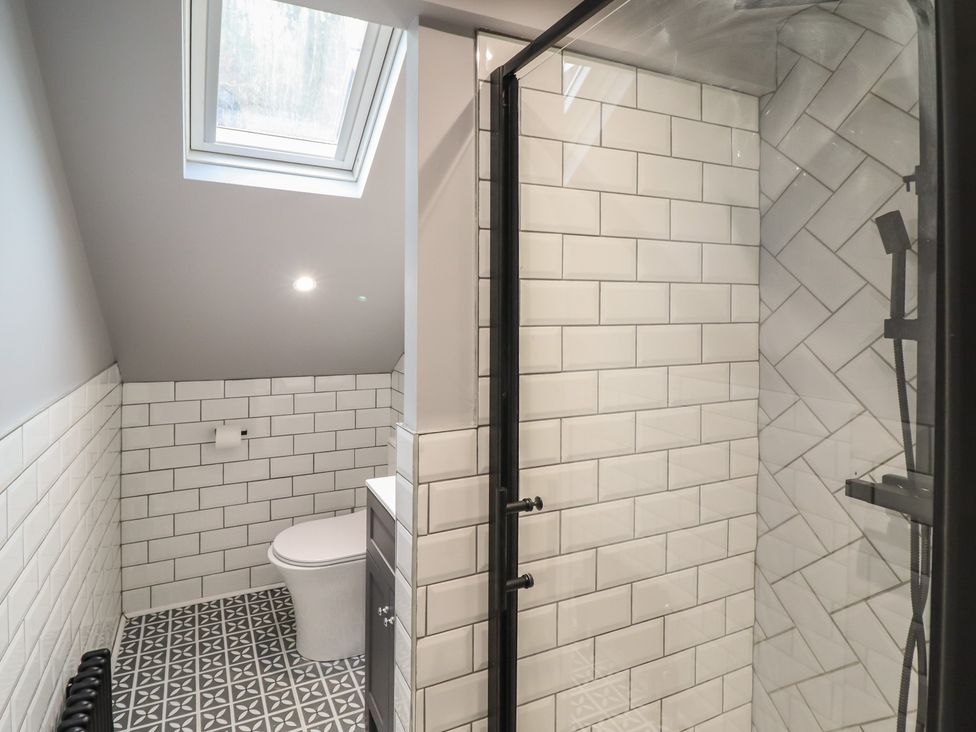 A bathroom with a shower and toilet at Green Bank in Betws-Y-Coed