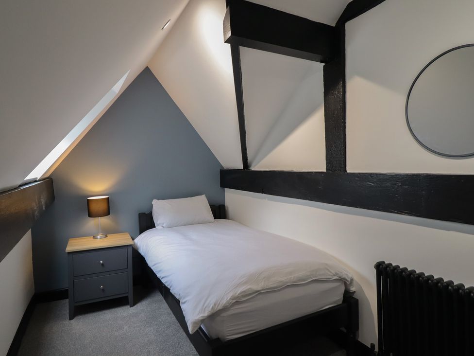 A bedroom with a bed and nightstand at Green Bank in Betws-Y-Coed