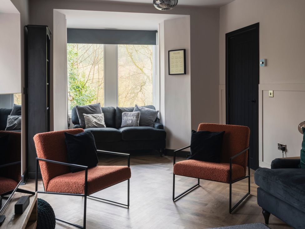 A living room with a sofa and chairs at Green Bank in Betws-Y-Coed