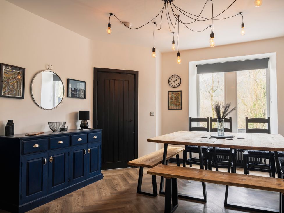 A dining room with table and chairs at Green Bank in Betws-Y-Coed