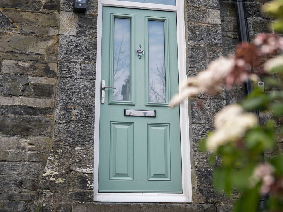 A door with a knocker and mail slot at Green Bank in Betws-Y-Coed