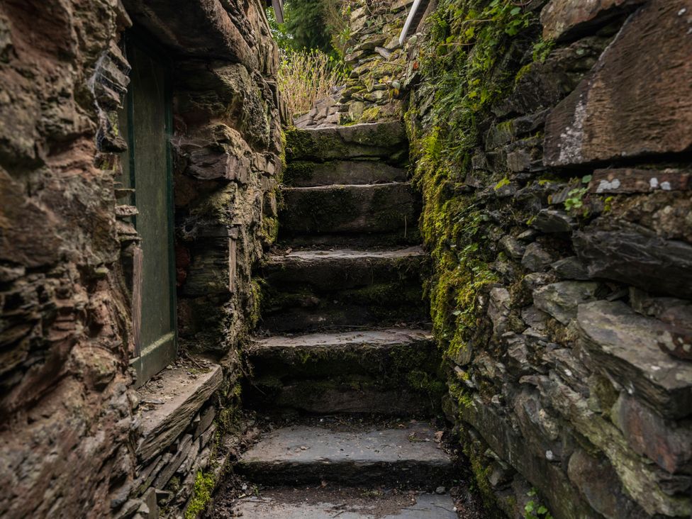 An outdoor staircase leading up through stone walls at Green Bank in Betws-Y-Coed
