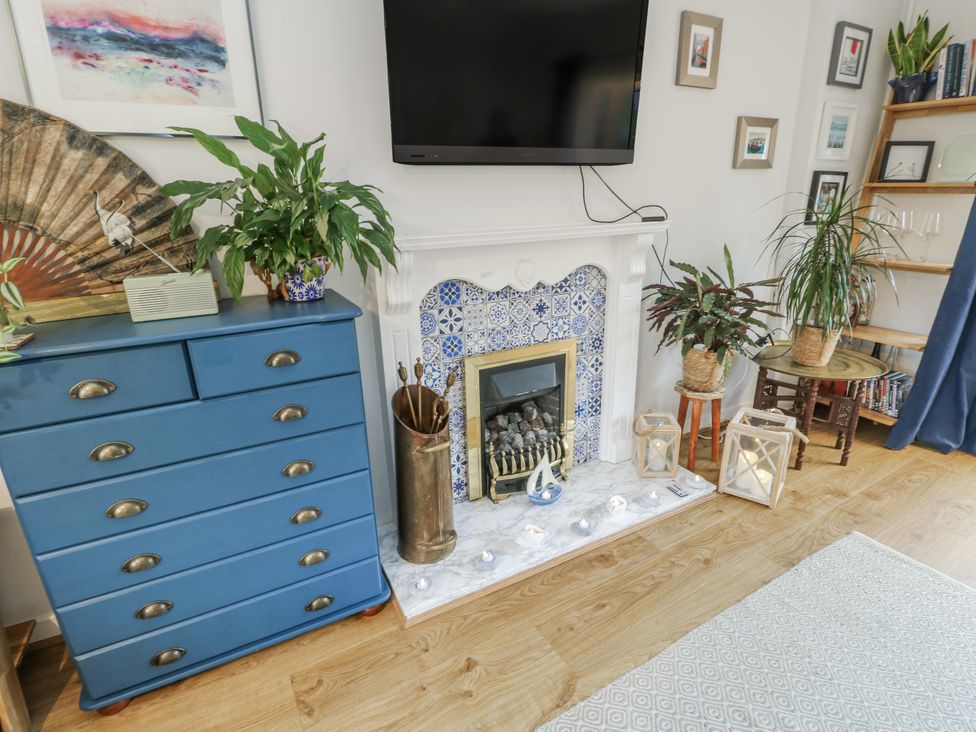 A living room with a television and fireplace at 16 Ffordd Meigan, Beaumaris