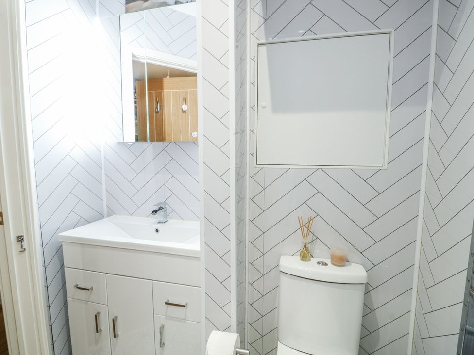 A bathroom with a sink and toilet at 16 Ffordd Meigan Beaumaris
