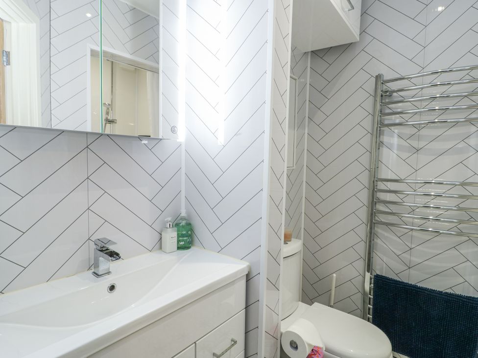 A bathroom with a sink and toilet at 16 Ffordd Meigan in Beaumaris