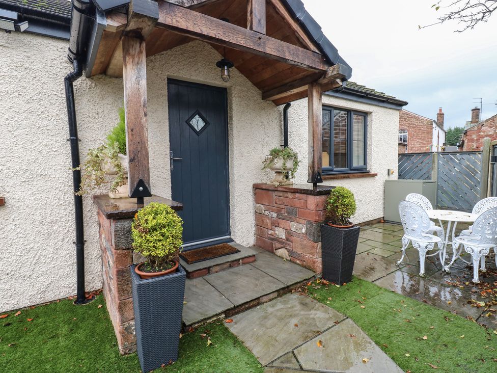 A garden entrance with steps and seating area at Cobble Cottage Long Marton near Appleby-In-Westmorland