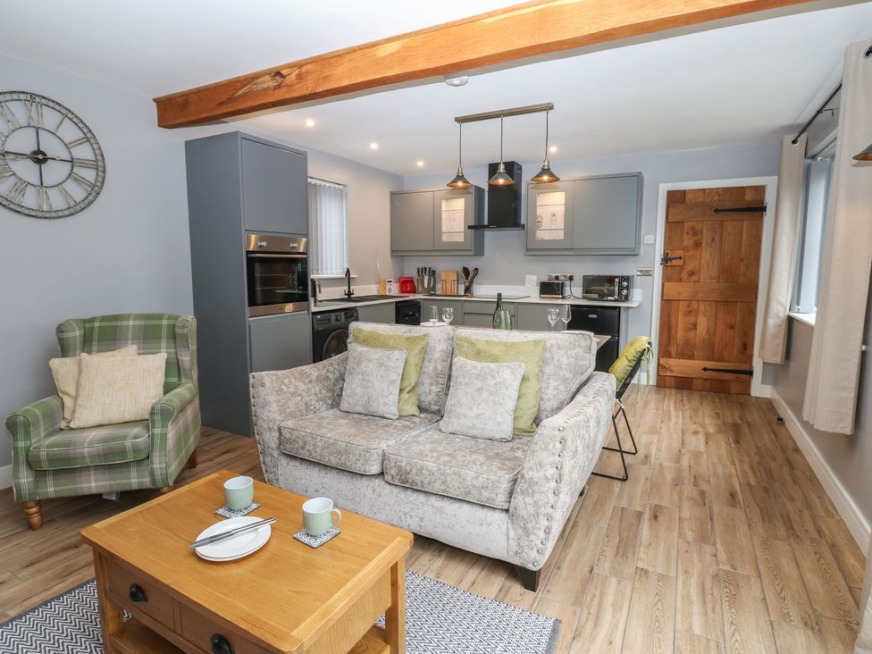 A living room with a sofa and coffee table at Cobble Cottage in Long Marton near Appleby-In-Westmorland