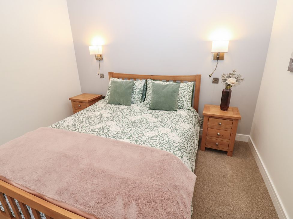 A bedroom with a bed and bedside tables at Cobble Cottage Long Marton near Appleby-In-Westmorland