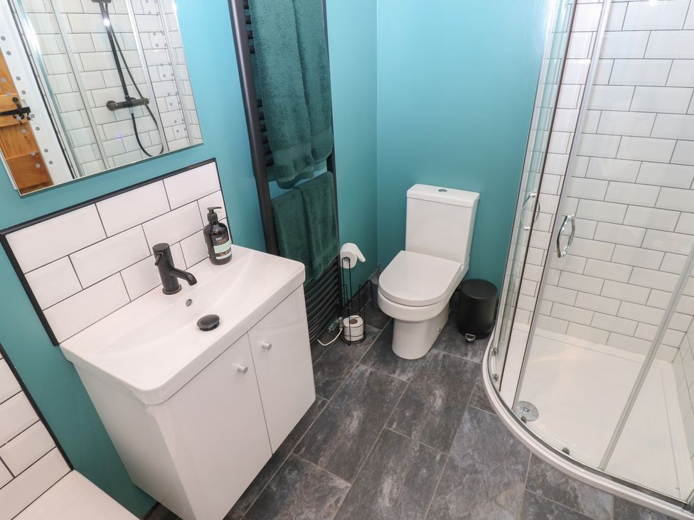 A bathroom featuring a sink, toilet, and shower at Cobble Cottage in Long Marton near Appleby-In-Westmorland