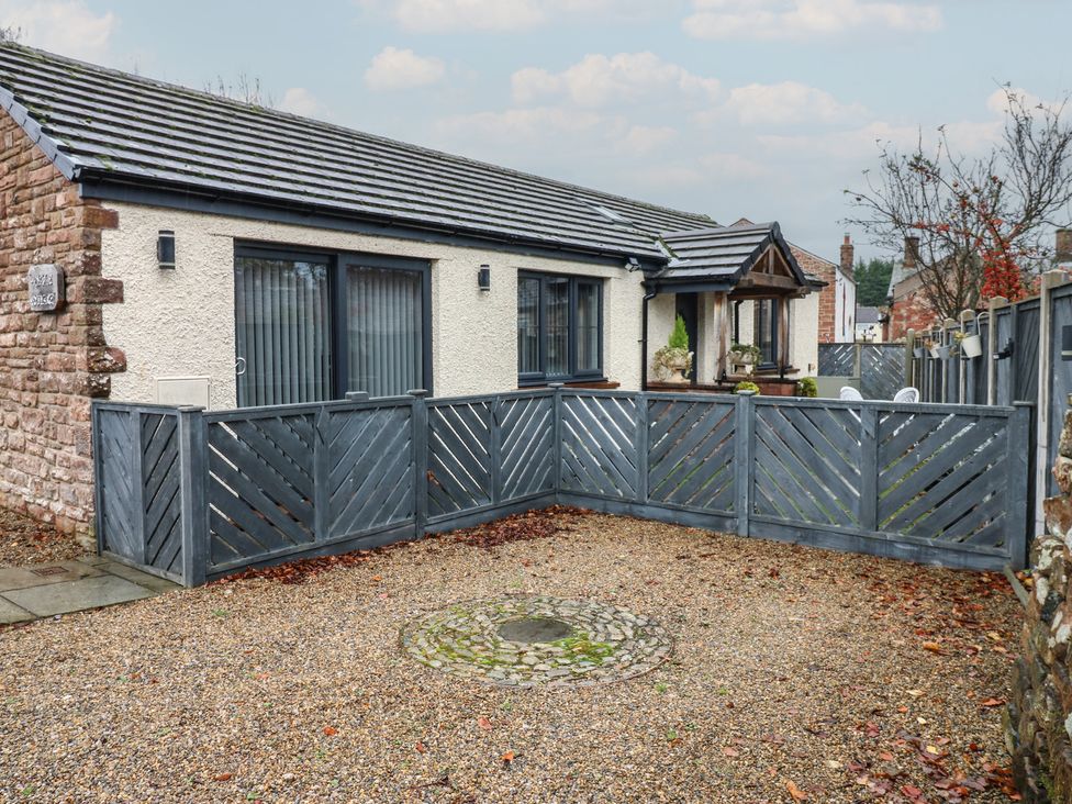 An exterior view of a house with a fenced garden at Cobble Cottage in Long Marton near Appleby-In-Westmorland