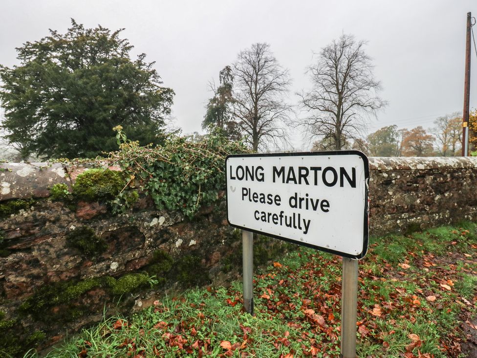 A road sign indicating Long Marton with a caution to drive carefully