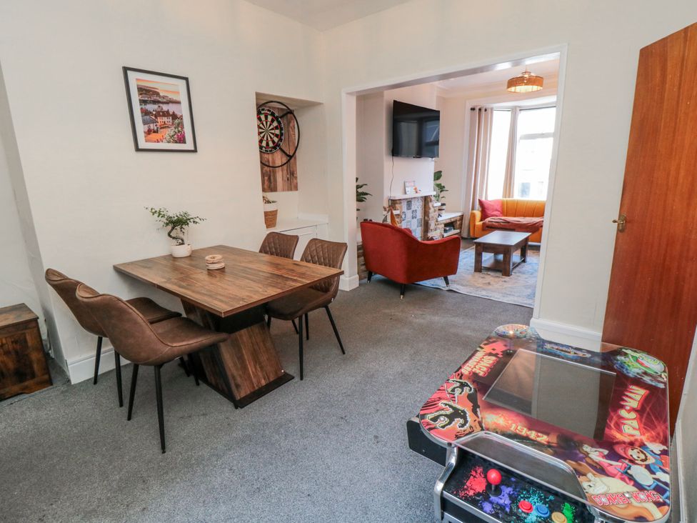 A dining room with a table and chairs at Captain Jacks in Whitby