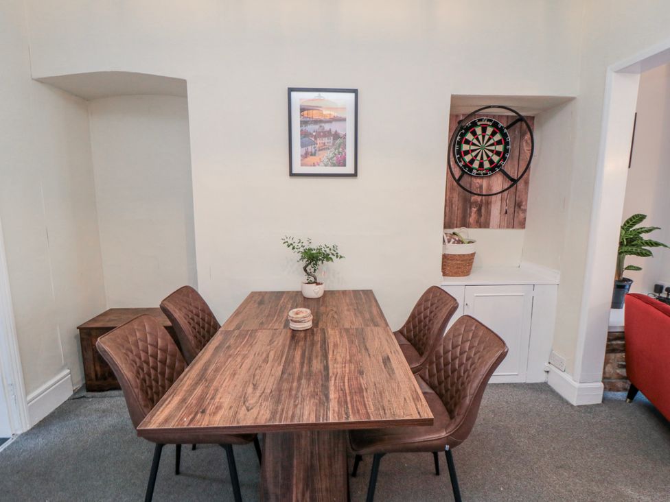 A dining room with a table and chairs at Captain Jacks in Whitby