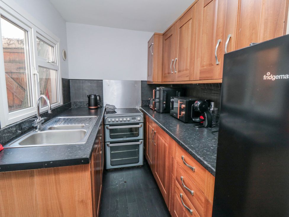 A kitchen with appliances and storage at Captain Jacks in Whitby