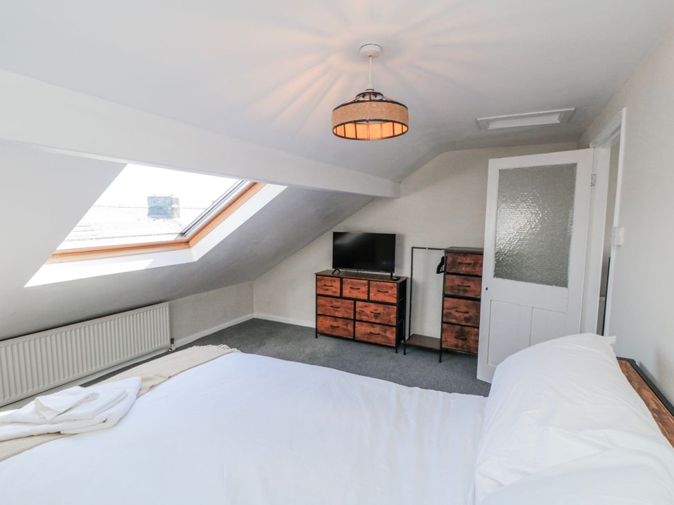 A bedroom with a bed and television at Captain Jacks in Whitby