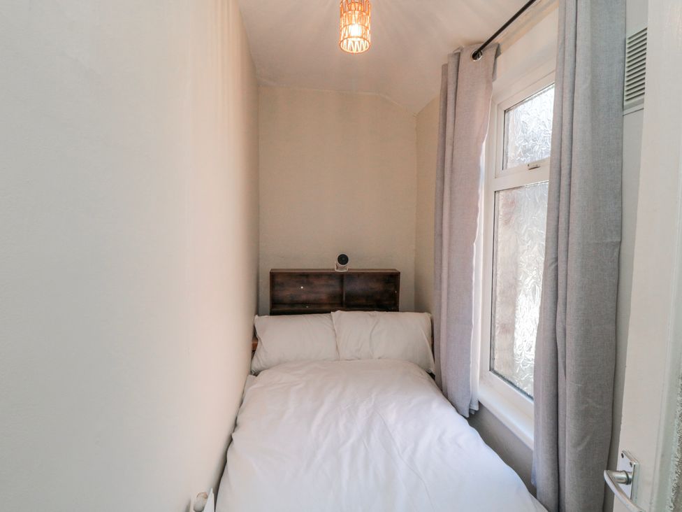 A bedroom with a bed and a window at Captain Jacks in Whitby