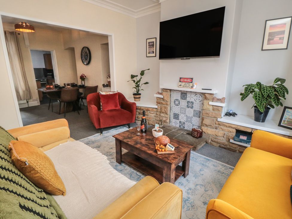 A living room with a coffee table and sofa at Captain Jacks in Whitby