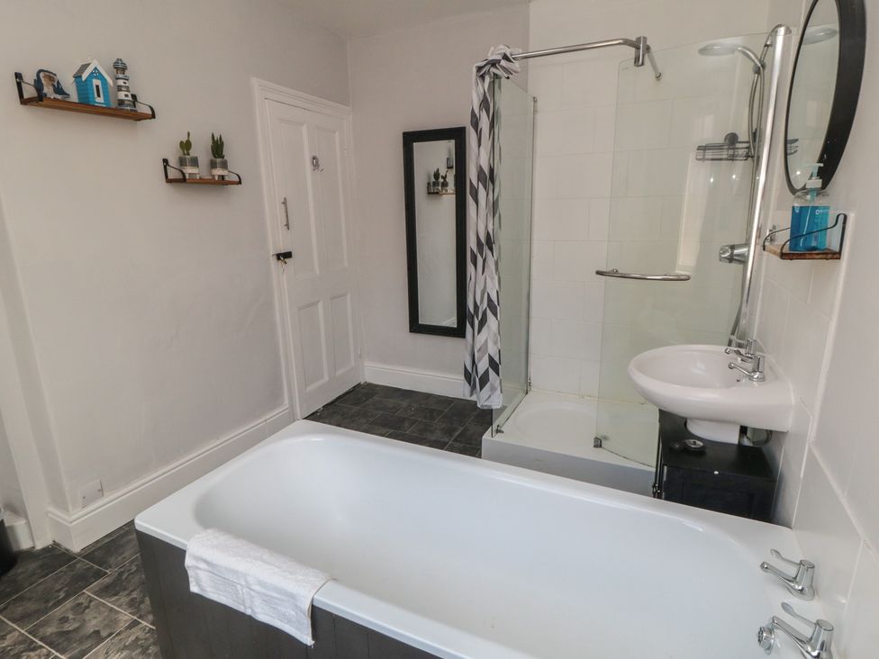 A bathroom with a bathtub and shower at Captain Jacks in Whitby