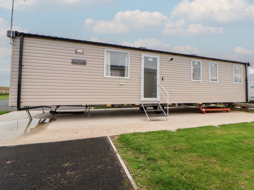 A mobile home with steps and windows at MC15 Rhyl