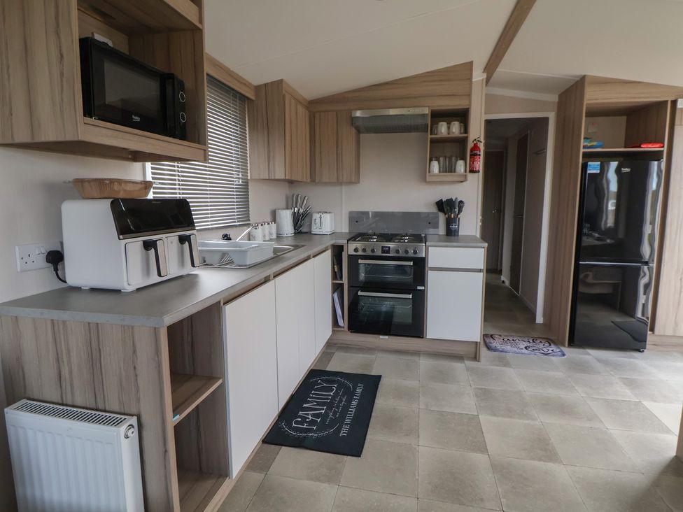 A kitchen with appliances and cabinetry at MC15 in Rhyl