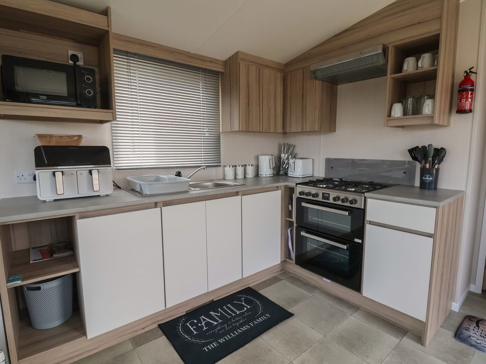 A kitchen with appliances and storage at MC15 Rhyl