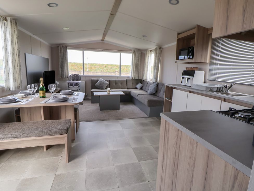 A living room with kitchen and dining area at MC15 in Rhyl