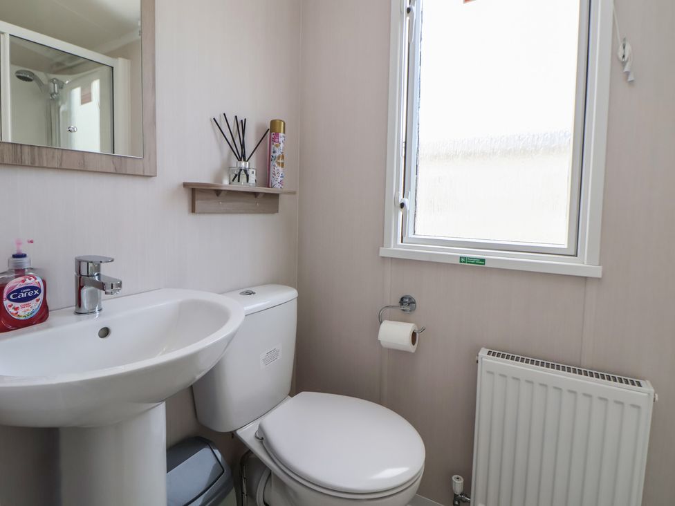 A bathroom with a sink and toilet at MC15 in Rhyl