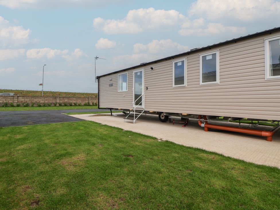 A mobile home with stairs and windows at MC15 in Rhyl