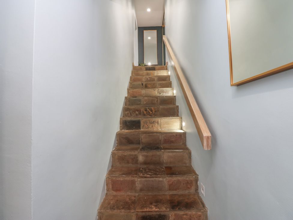 A staircase with stone steps and light fixtures at Chapel Hill in Catlowdy
