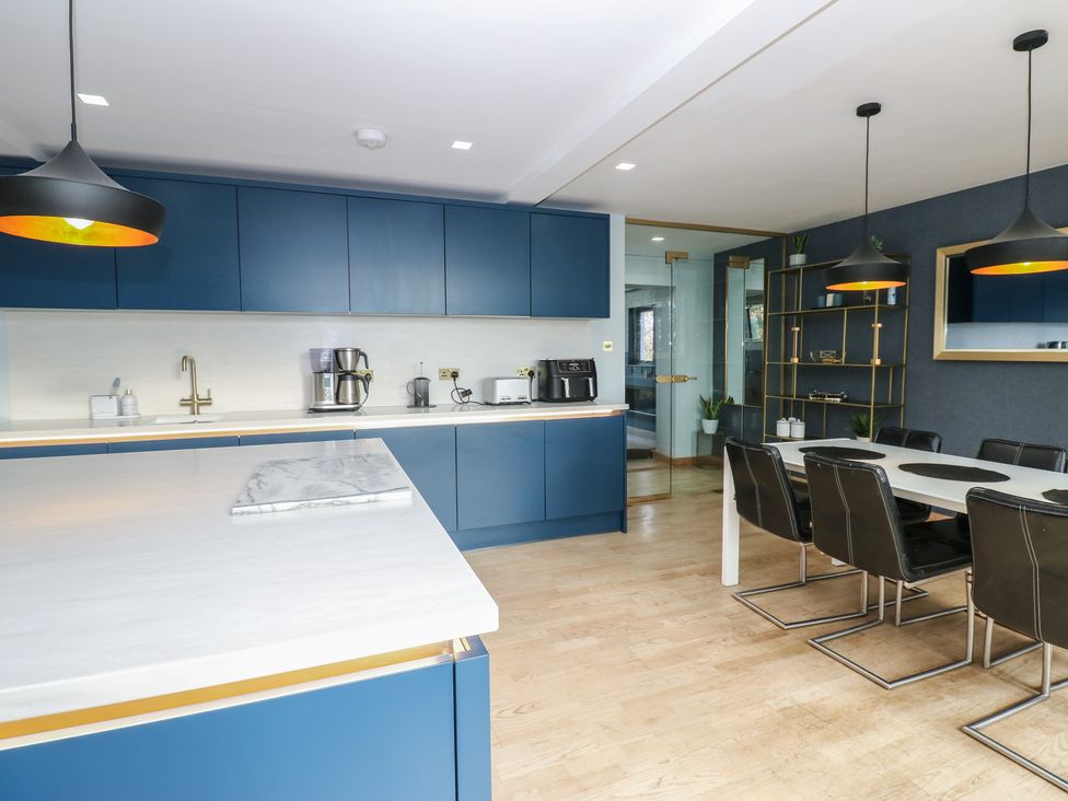 A kitchen with a dining area and appliances at Chapel Hill in Catlowdy