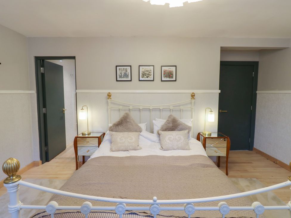 A bedroom with a bed and bedside tables at Chapel Hill in Catlowdy