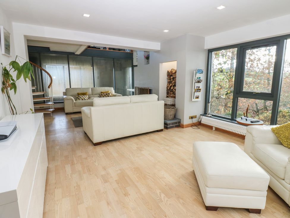 A living room with a sofa and windows at Chapel Hill in Catlowdy