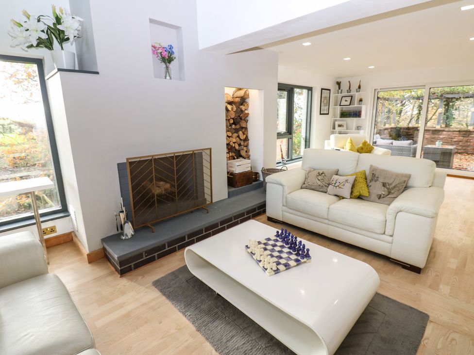 A living room with a sofa and chess set at Chapel Hill in Catlowdy