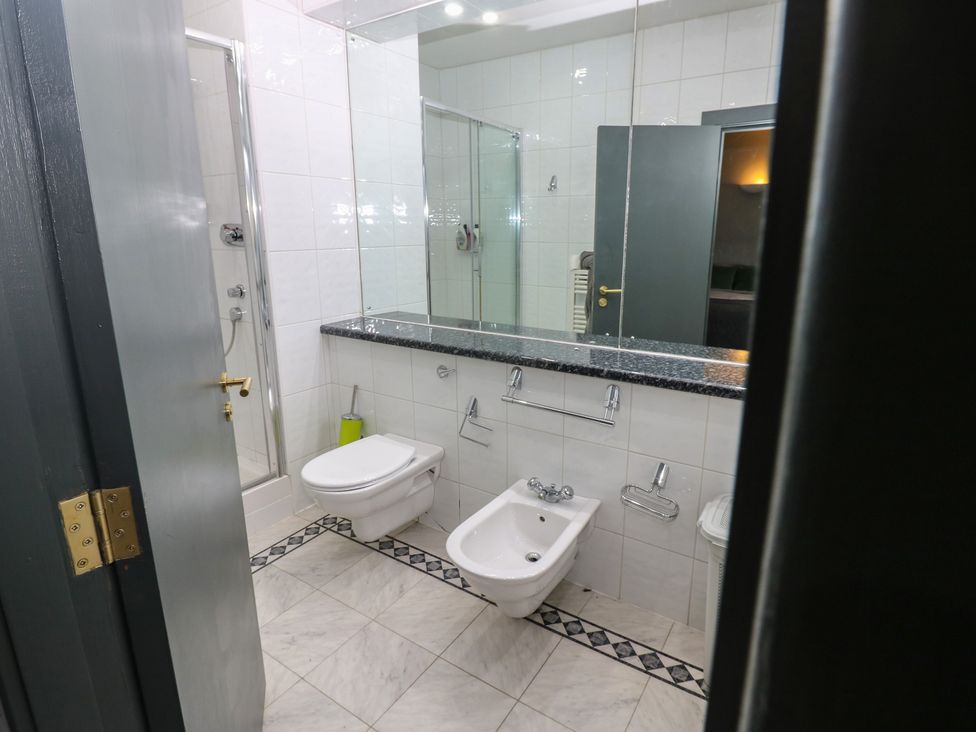 A bathroom with a shower, toilet and sink at Chapel Hill in Catlowdy