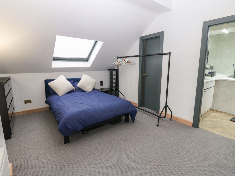 A bedroom with a bed and dresser at Chapel Hill in Catlowdy