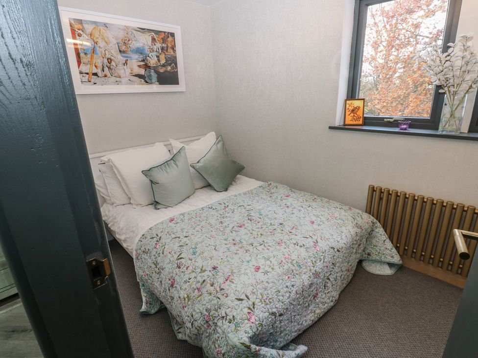 A bedroom with a bed and wall art at Chapel Hill in Catlowdy
