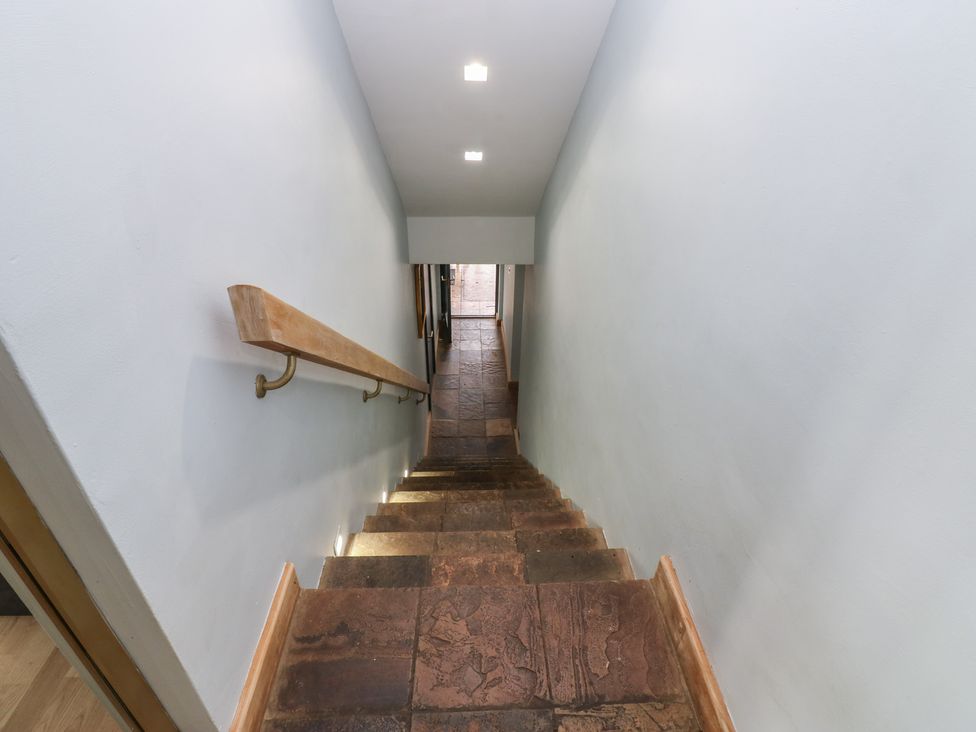 A staircase with stone steps and a handrail at Chapel Hill in Catlowdy