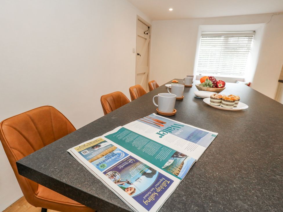 A kitchen with a large table and chairs at Long Barn in Burton Bradstock