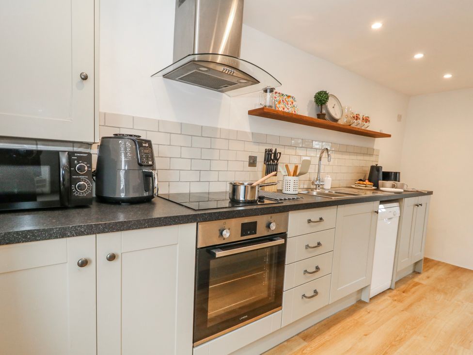 A kitchen with appliances and utensils at Long Barn in Burton Bradstock