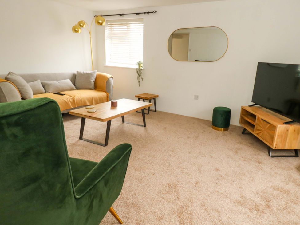 A living room with a sofa and coffee table at Long Barn in Burton Bradstock