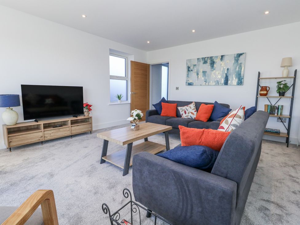 A living room with a sofa and television at Seafern House 36B in Poole