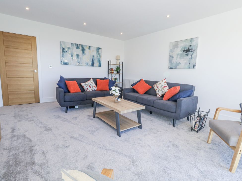 A living room with sofas and a coffee table at Seafern House 36B in Poole