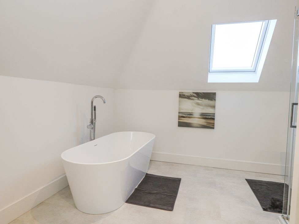 A bathroom with a bathtub and shower at Seafern House 36B in Poole
