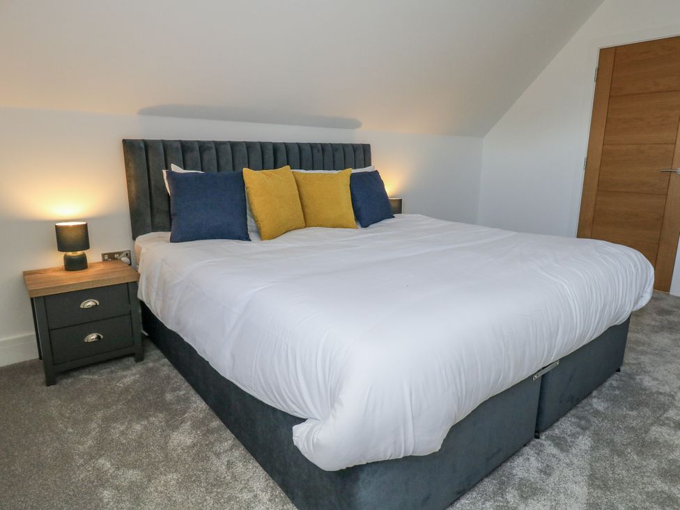 A bedroom with a bed and nightstand at Seafern House 36B in Poole